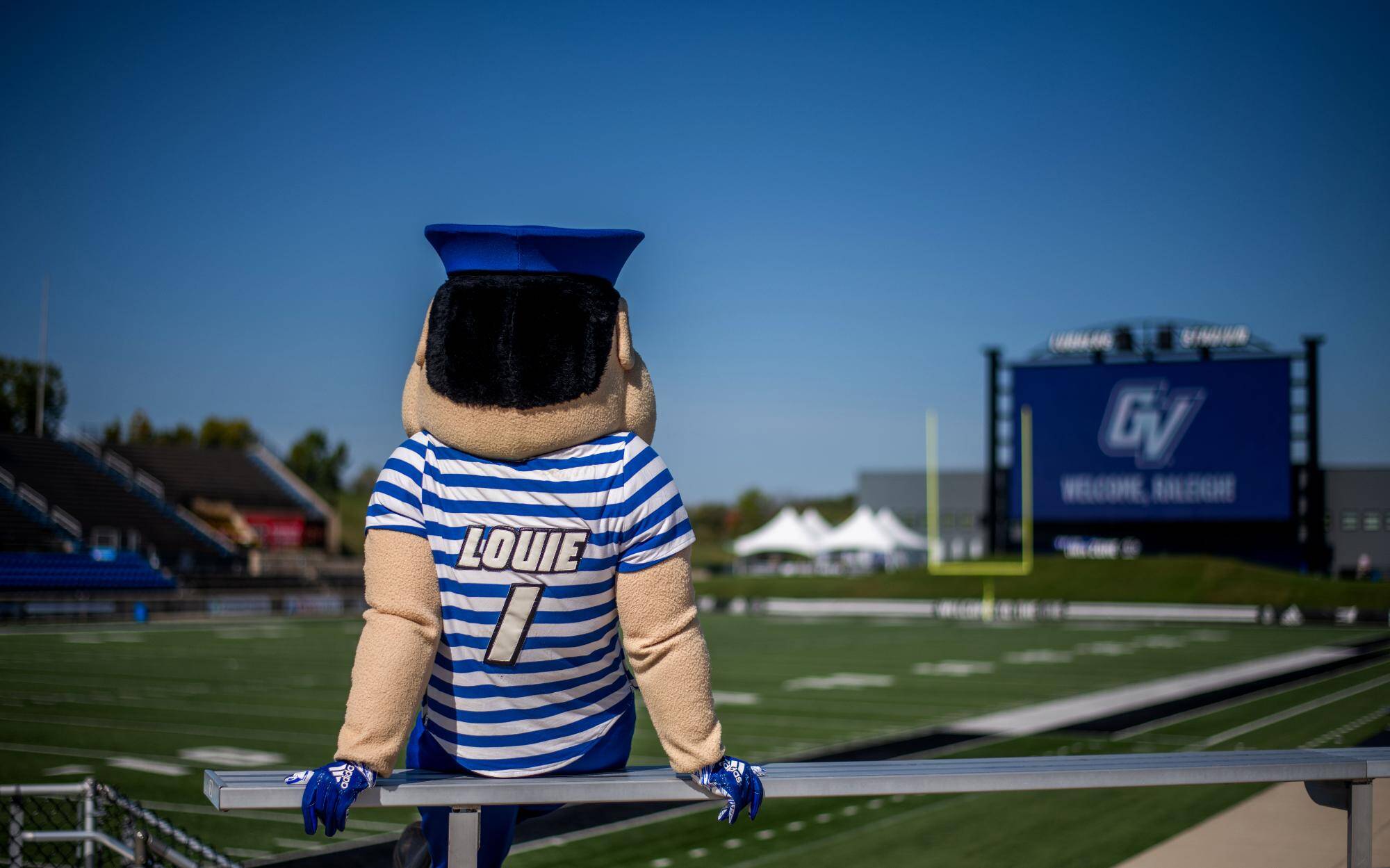 Back of Louie the Laker looking at GVSU Football Scoreboard